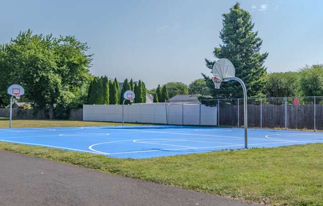 a blue basketball court in a park with two basketball hoops at Glen Hollow, Croydon, Pennsylvania