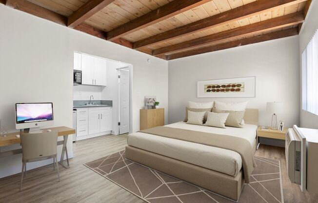 a bedroom with a bed and a tv