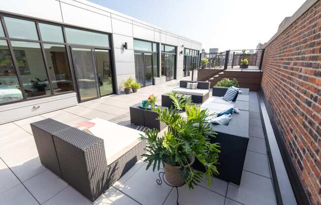 a view of the roof terrace with seating and potted plants