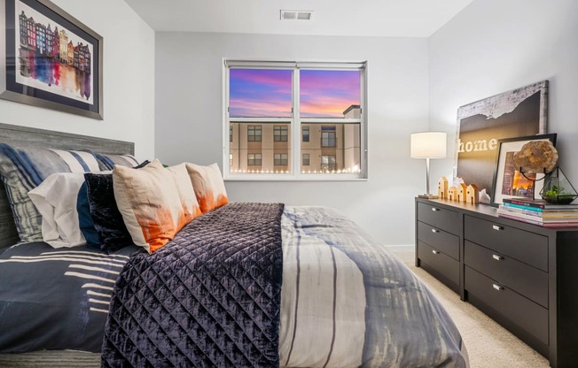 a bedroom with a bed and a window