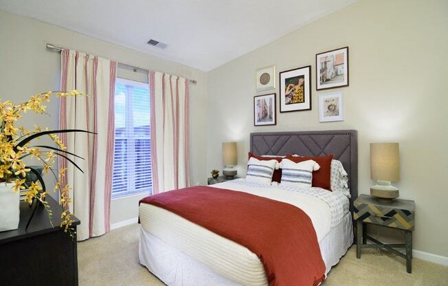 a bedroom with a bed and some pictures on the wall