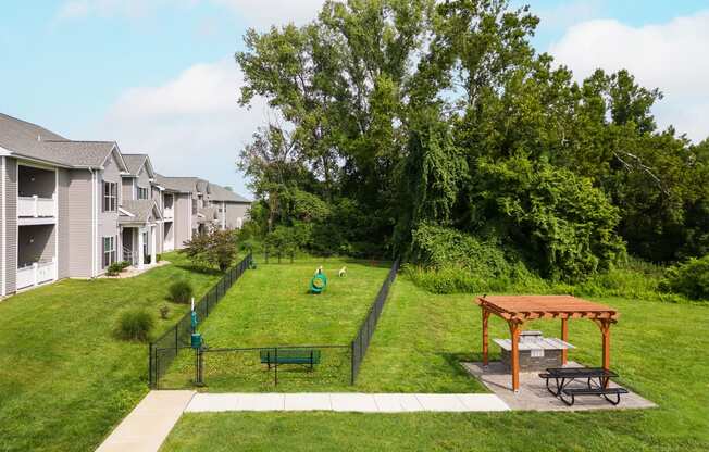 a backyard with a dog park and a picnic table