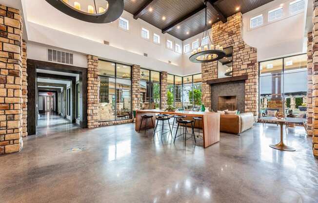 A modern open plan living space with a stone fireplace.