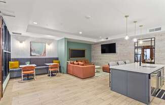A modern living room with a grey sofa and a wooden floor.