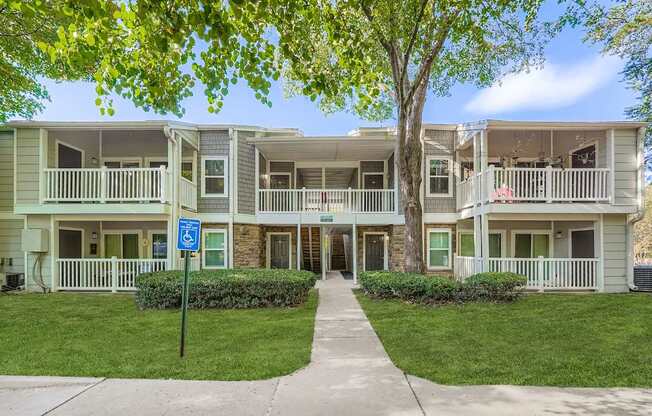 Apartment complex with a blue sign in front.