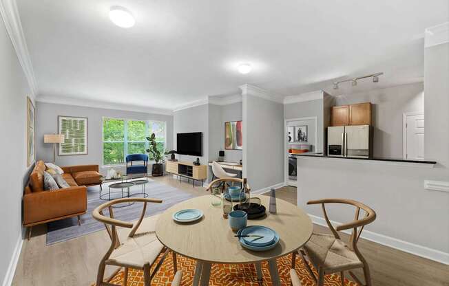 A dining room with a round table set for two.