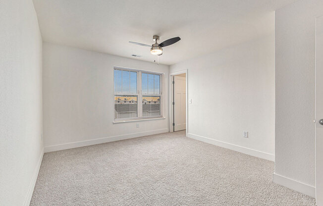 Bedroom with a walk in closet and a large window  at Signature Pointe Apartment Homes, Athens, AL, 35611