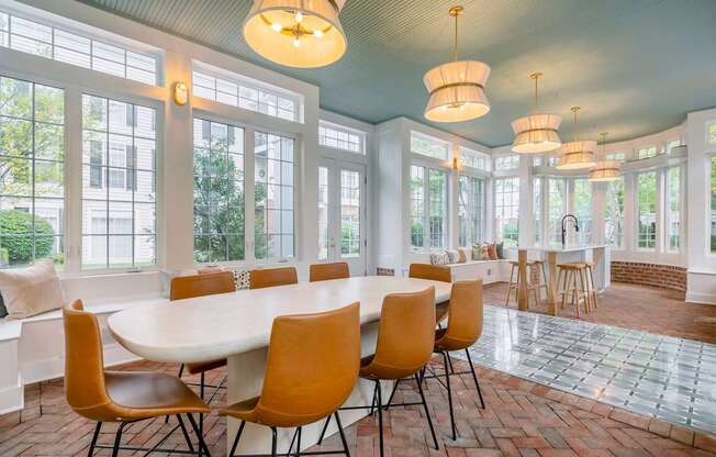 A dining room with a white table and chairs.