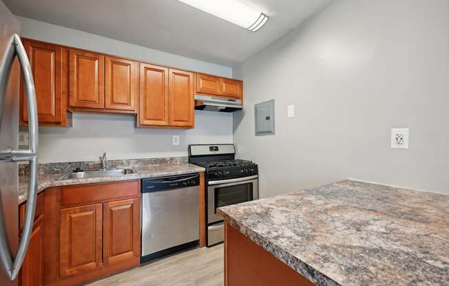 a kitchen with granite counter tops and stainless steel appliances at ReNew Odenton