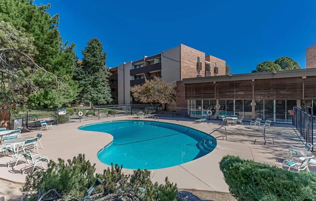 a community pool with green plants