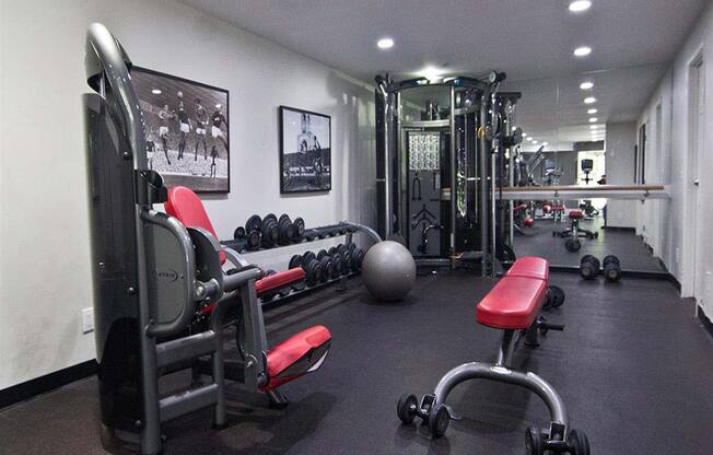 Modern fitness center with cardio and weightlifting equipment at Camelot East Apartments, Fairfield, 45014