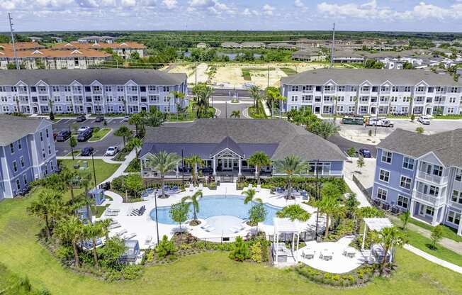 an aerial view of a resort with a large swimming pool