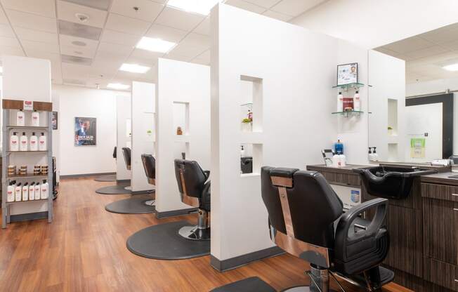 a salon with white walls and wood flooring