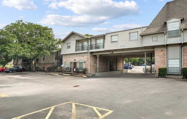 A parking lot with a building in the background.