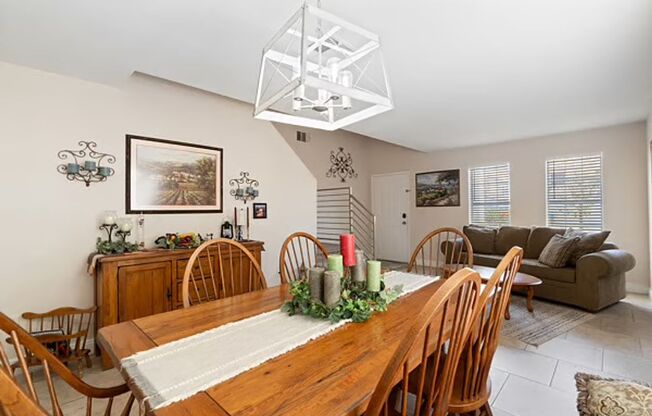 House has open kitchen with crisp white cabinetry with large backyard.