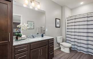 A bathroom with a toilet, sink, and shower.