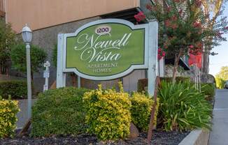 a sign homes in front of plants