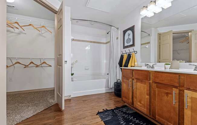 a bathroom with a shower and a sink and a mirror