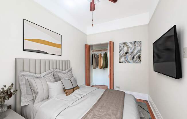 a bedroom with a large bed and a ceiling fan