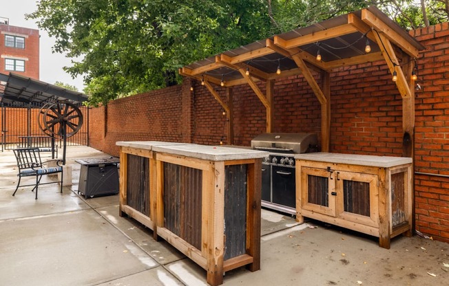 A patio with a grill and a table.