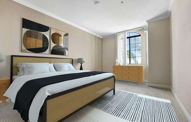 A bedroom with a large bed and a wooden dresser.