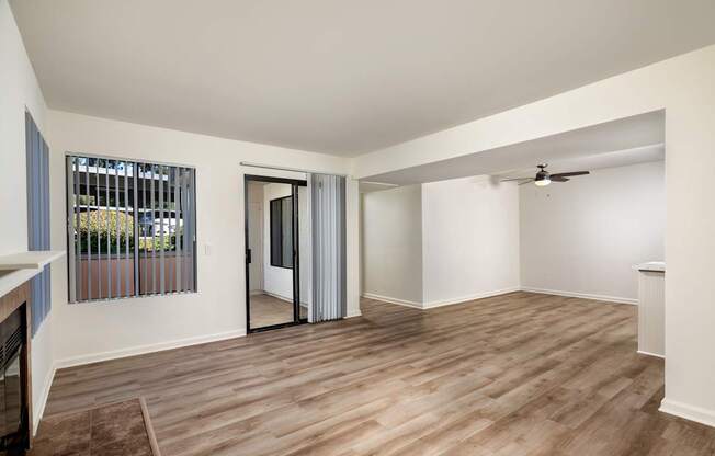 A room with a sliding door and a ceiling fan.