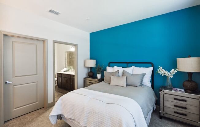 Bedroom with Blue Wall and a Mirror at The Loree, Jacksonville, FL, 32256