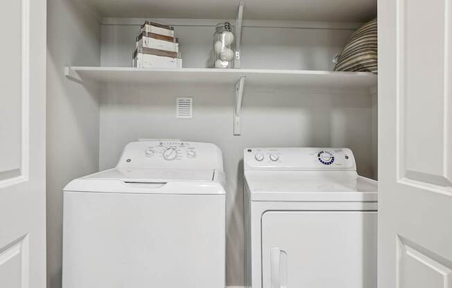 A white washing machine and dryer in a laundry room.