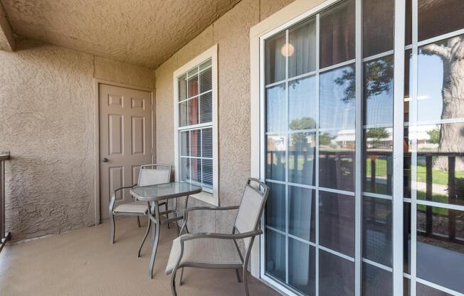 Stucco wall patio with floor to ceiling windows at ABQ Apartments