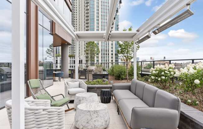 a living area with couches and chairs and a balcony with tall buildings at Cassidy on Canal, Chicago, IL, 60654