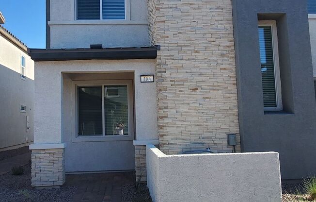 Contemporary townhome with modern exterior and attached garage.