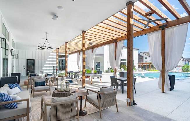 a rendering of a patio area with chairs and tables and a pool in the background