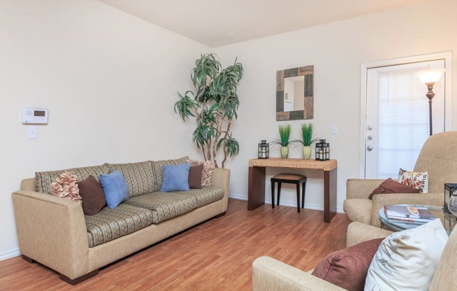 a living room with a couch and a chair and a table