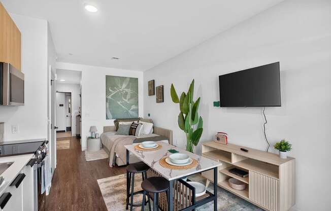 A modern kitchen with a dining table set for two at The Indie in Allston.
