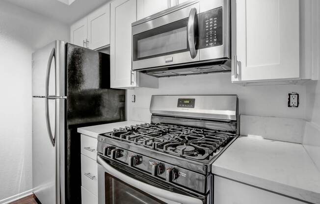 a kitchen with a stove top oven next to a refrigerator