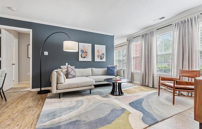 model home living room view with expansive windows