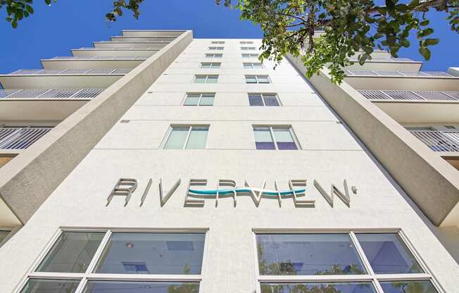 1- & 2-Bedroom Apartments for Rent in Miami, FL – Riverview One Apartments – A white building with the word "RIVERVIEW" on the side.