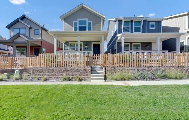 a row of houses with a sidewalk in front of them