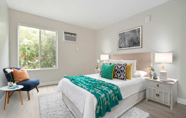 Bedroom with air conditioning, wood-inspired floors, sliding window