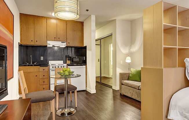 a studio apartment with a kitchen and living room
