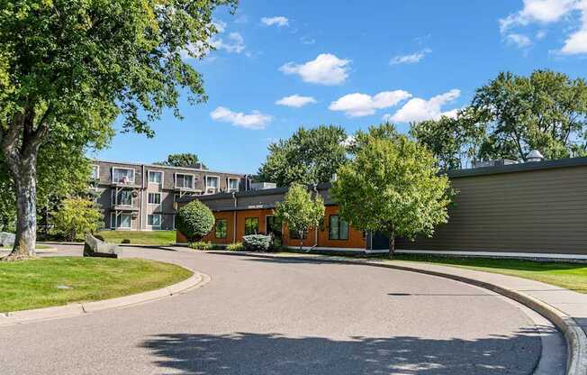 A sunny day at a residential area with a curved road and houses.