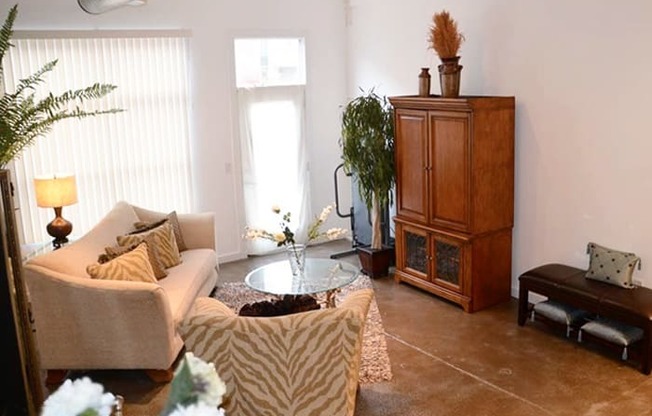 a living room filled with furniture and a large window