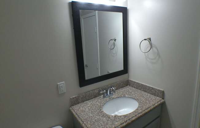 a small bathroom with a sink and a mirror