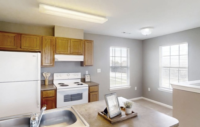 A kitchen with white appliances and wooden cabinets