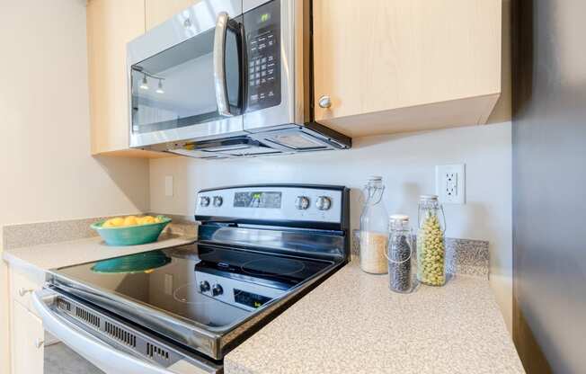 a kitchen with a stove and microwave in a 555 waverly unit at Heritage Bay, Jensen Beach, FL 34957