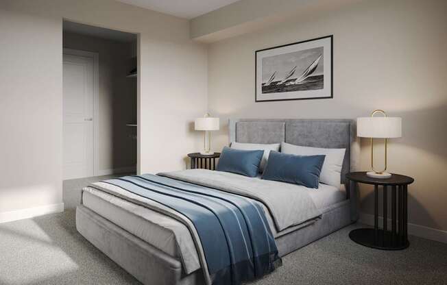 A bedroom with a bed, two lamps, and a picture on the wall.