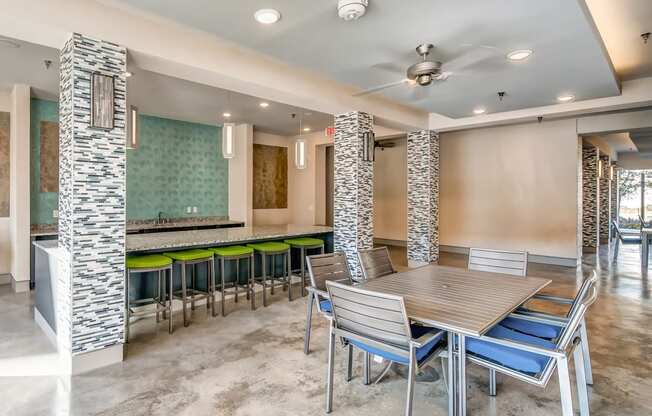 a dining area with a table and chairs and a bar