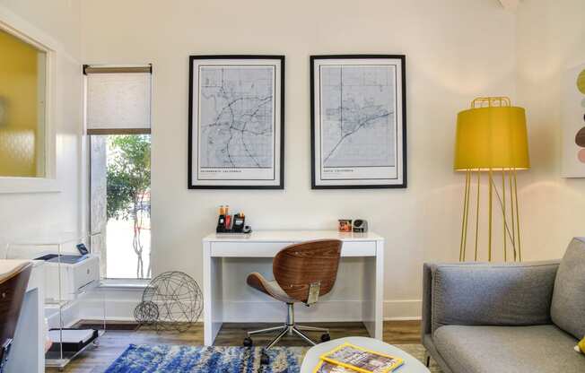 a home office with a white desk and a yellow lamp at Renaissance Park Apartments, Davis, CA