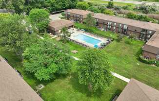 Expansive green space and heated pool at Drawbridge Apartments in Harrison Township, MI.