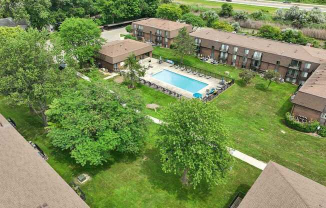 Expansive green space and heated pool at Drawbridge Apartments in Harrison Township, MI.